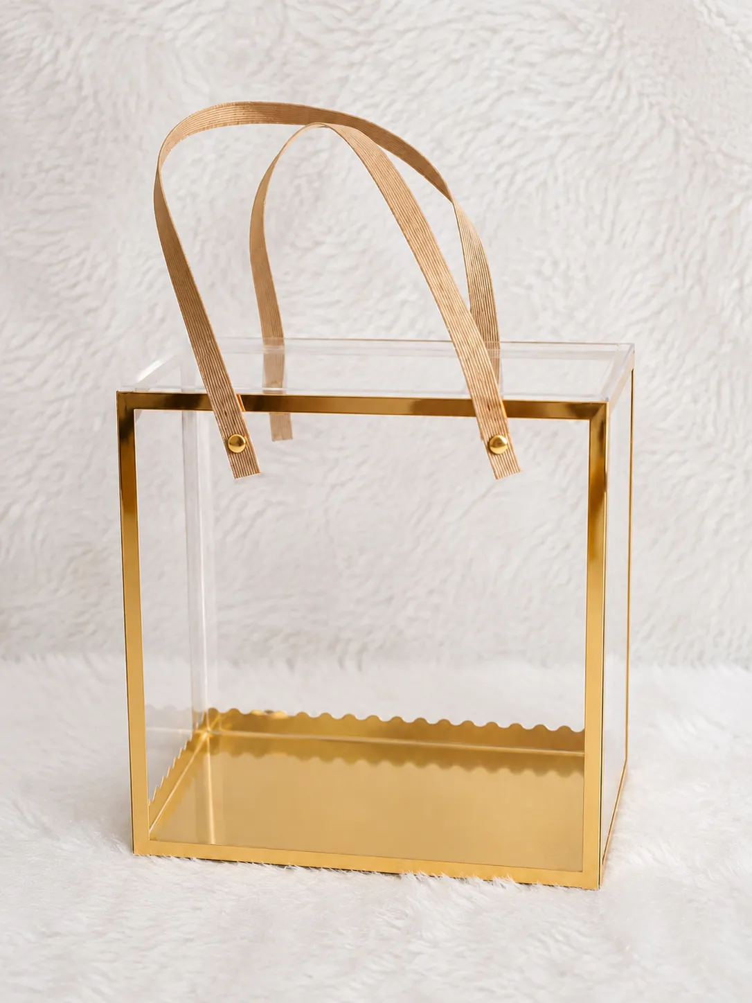  Clear acrylic box featuring elegant gold handles, showcasing a modern and stylish design.